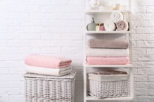 Shelving,Unit,And,Baskets,With,Clean,Towels,And,Toiletries,Near