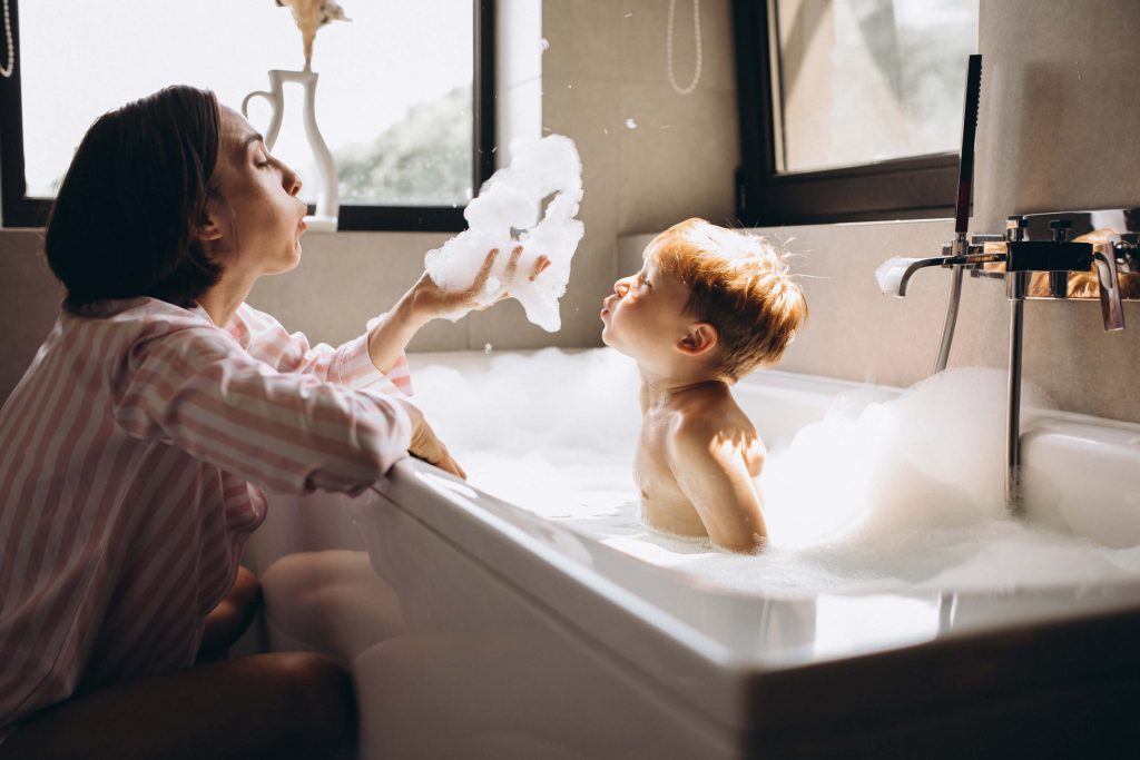 baby being washed in bathtub