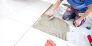 Person tiling a bathroom floor