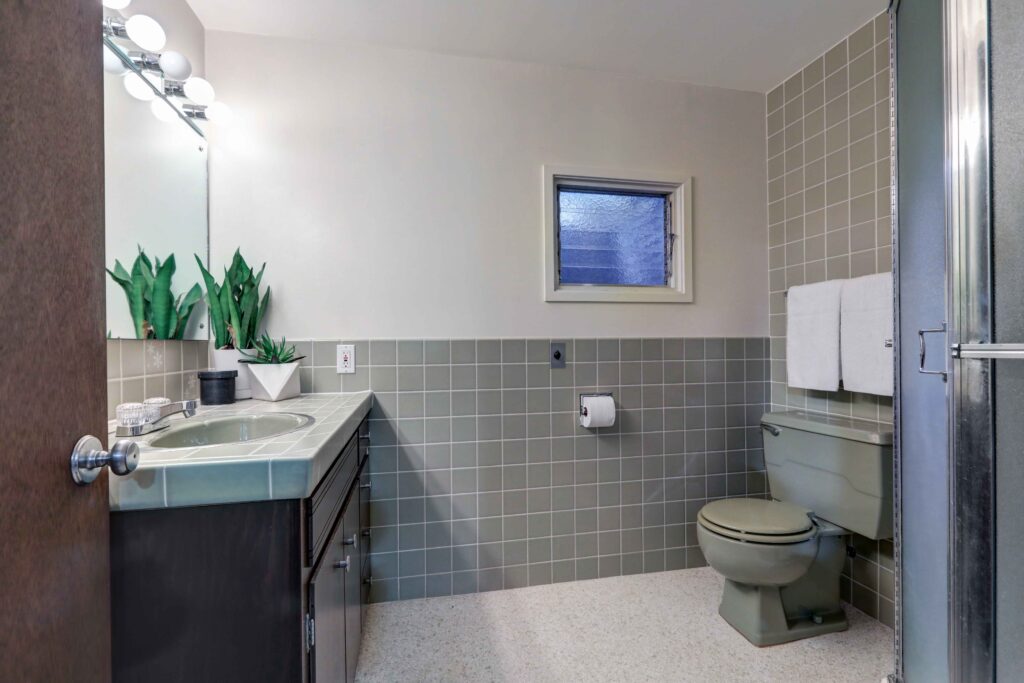 Half tiled, grey-green bathroom