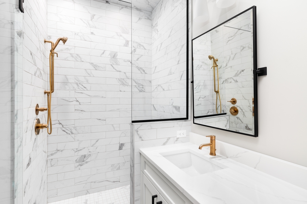 Hotel Bathroom With Brass Accents & Statement Glass